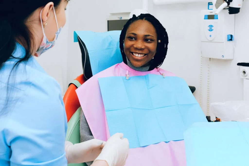Dentist examining a patient's gums — periodontal disease is a recognised complication of poorly controlled diabetes