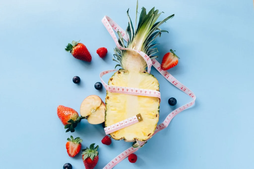 Healthy fruits with measuring tape representing careful dietary choices for diabetes management