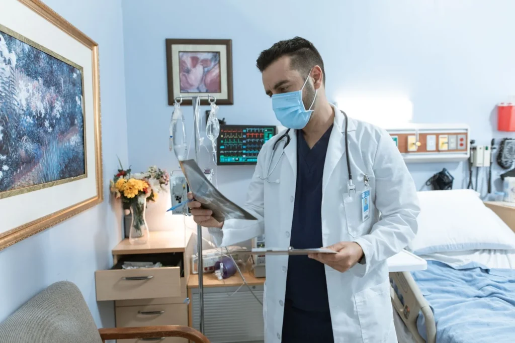 Home care nurse visiting a diabetes patient at home for blood glucose monitoring and medication review