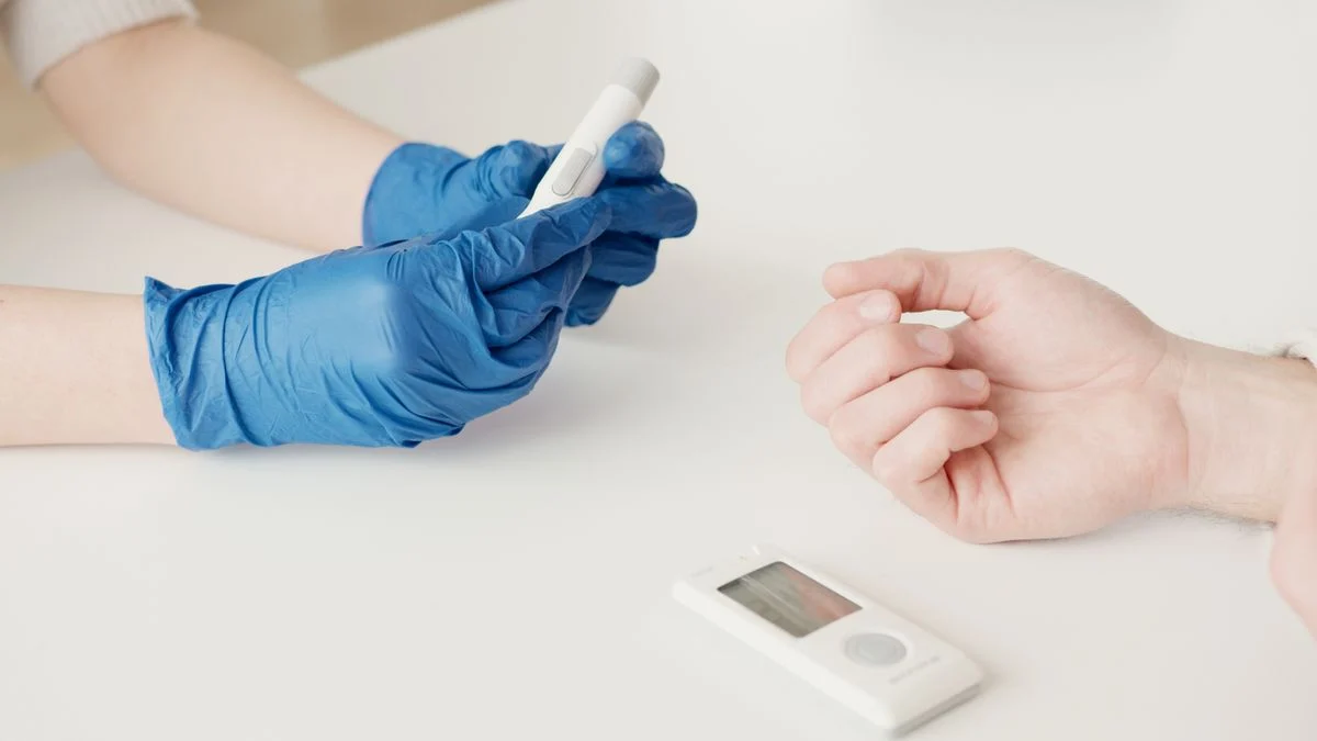 Healthcare professional monitoring blood sugar levels in a patient