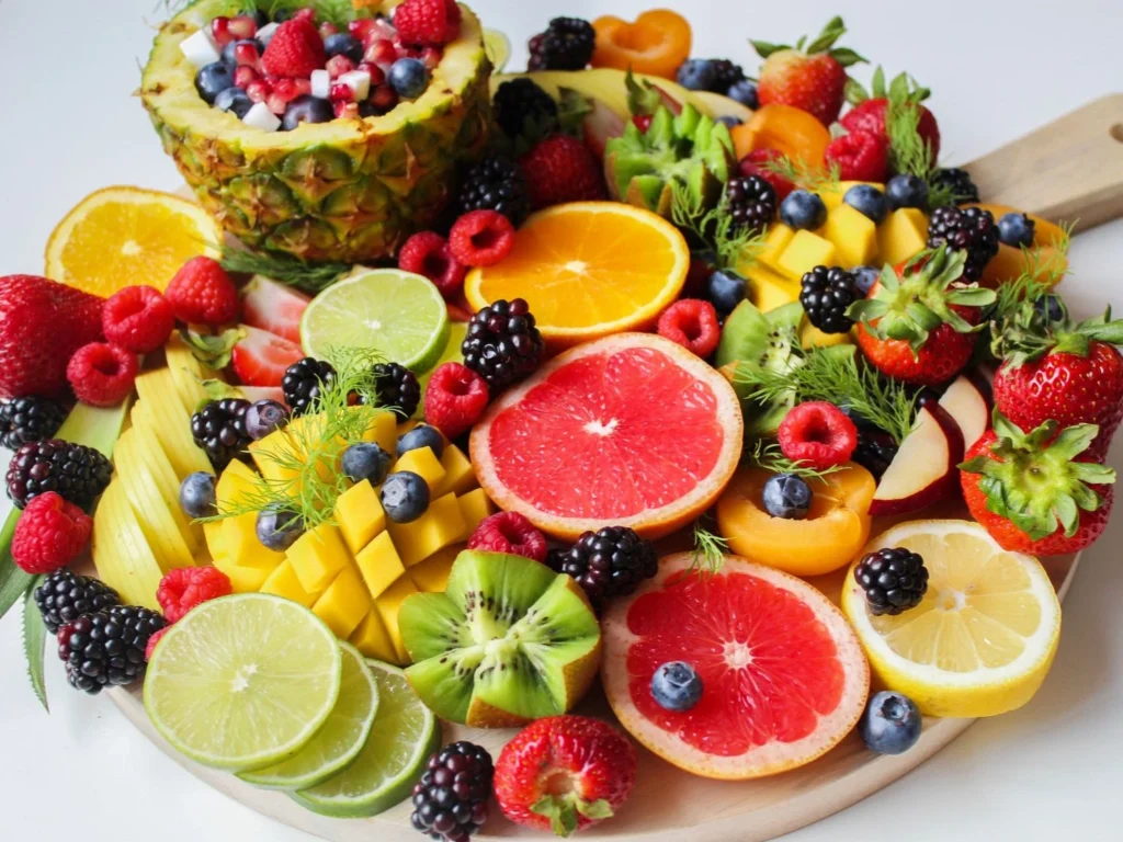 Fruit plate with mango and other tropical fruits paired with yogurt to slow blood sugar rise