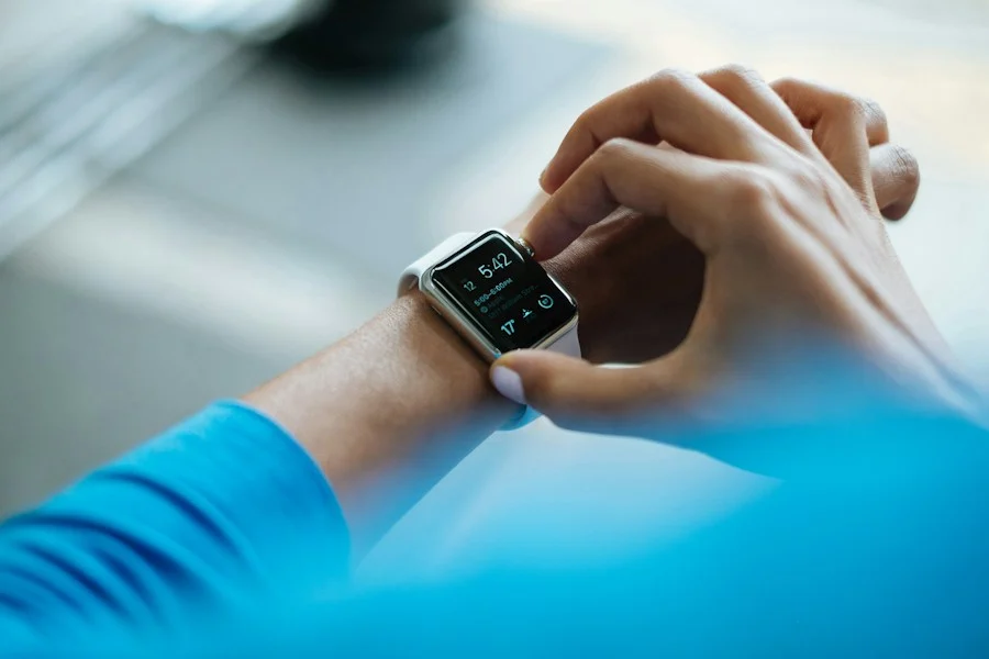 Person checking blood glucose monitor after meals — tracking blood sugar responses to stevia