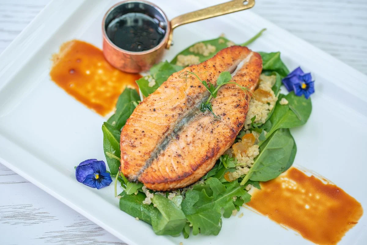 Grilled fish served with green vegetables on a white plate — a diabetes-friendly high-protein meal