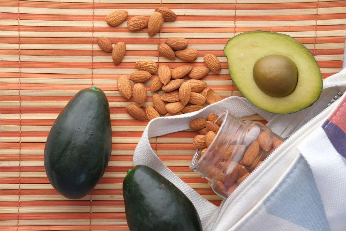 Avocados beside almonds — healthy unsaturated fats that support blood sugar management